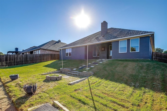 rear view of property featuring a yard