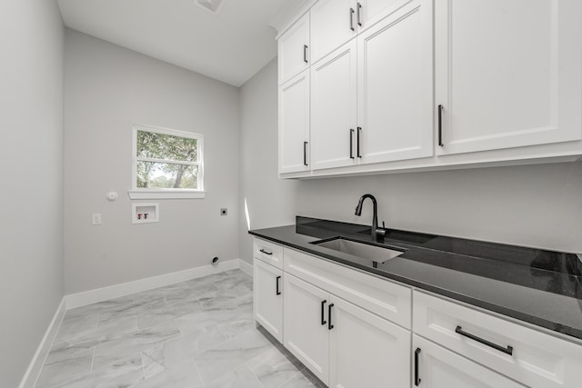 washroom with cabinets, hookup for an electric dryer, sink, and washer hookup