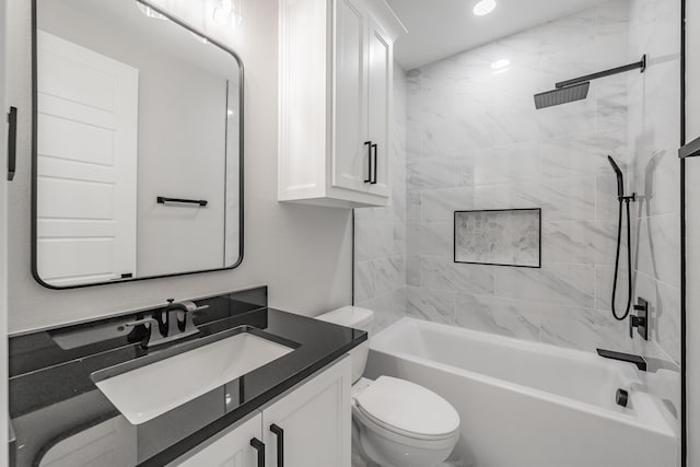 full bathroom with vanity, tiled shower / bath, and toilet