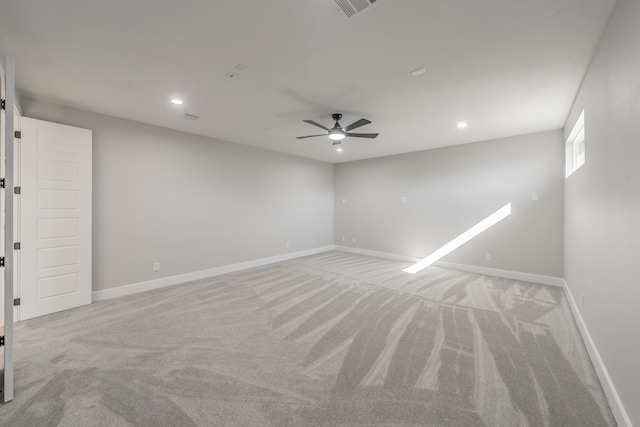 carpeted spare room with ceiling fan