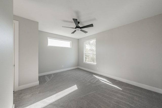 empty room with ceiling fan and carpet flooring