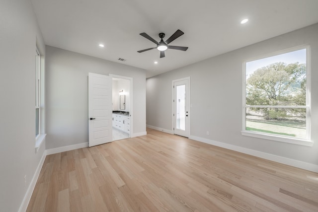 unfurnished bedroom with light hardwood / wood-style flooring, ceiling fan, and ensuite bath