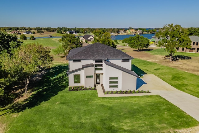 view of front of property featuring a front yard and a water view