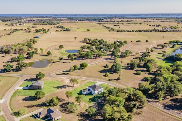 drone / aerial view featuring a water view and a rural view