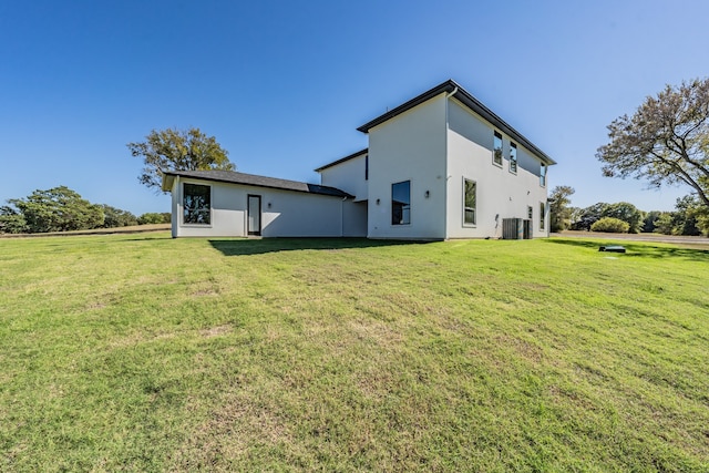 back of house with a yard and central AC unit