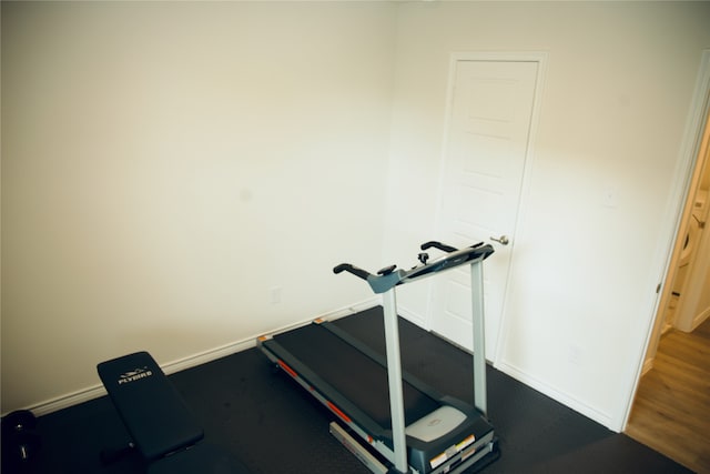 exercise room with wood-type flooring