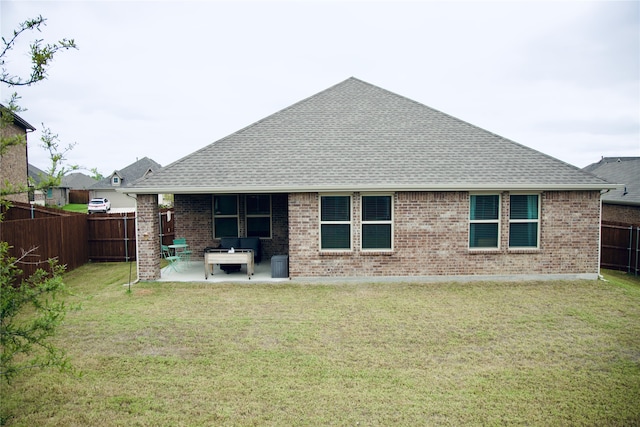 rear view of house with a lawn and a patio area