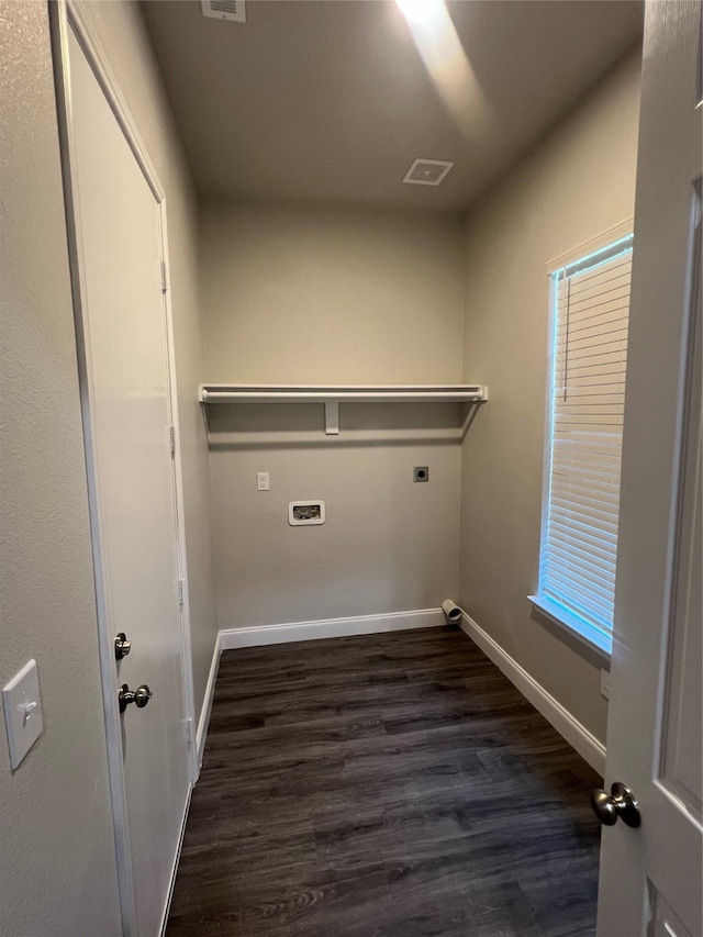 laundry room featuring electric dryer hookup and dark hardwood / wood-style flooring