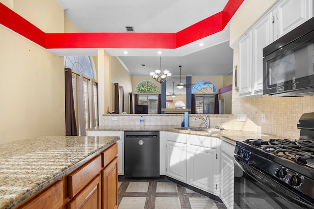 kitchen with black appliances, white cabinetry, tasteful backsplash, and sink