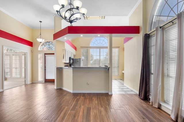 kitchen with dark hardwood / wood-style floors, a healthy amount of sunlight, and white cabinetry