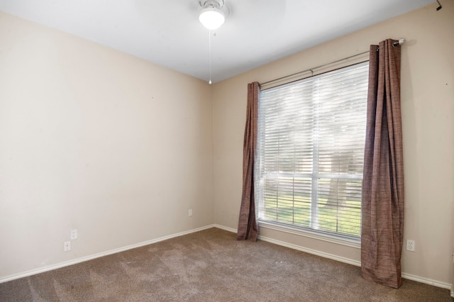 spare room featuring carpet flooring and ceiling fan