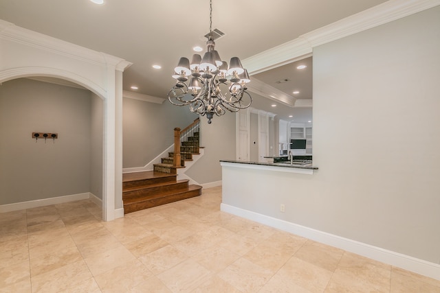 interior space featuring crown molding, sink, and a notable chandelier