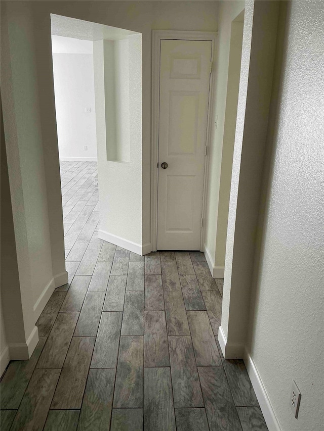 corridor with wood-type flooring