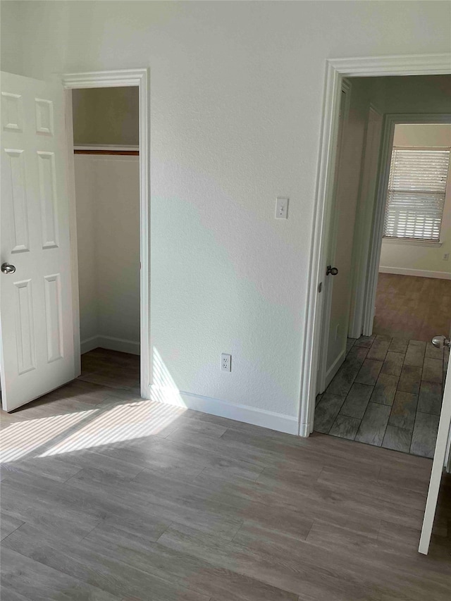 unfurnished bedroom featuring a closet and hardwood / wood-style flooring