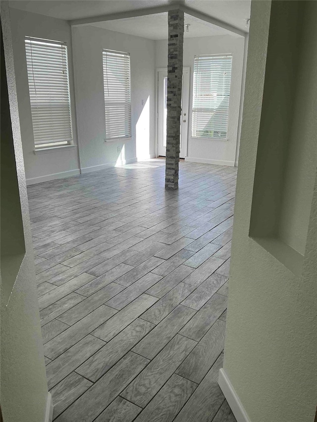 spare room with light wood-type flooring and ornate columns