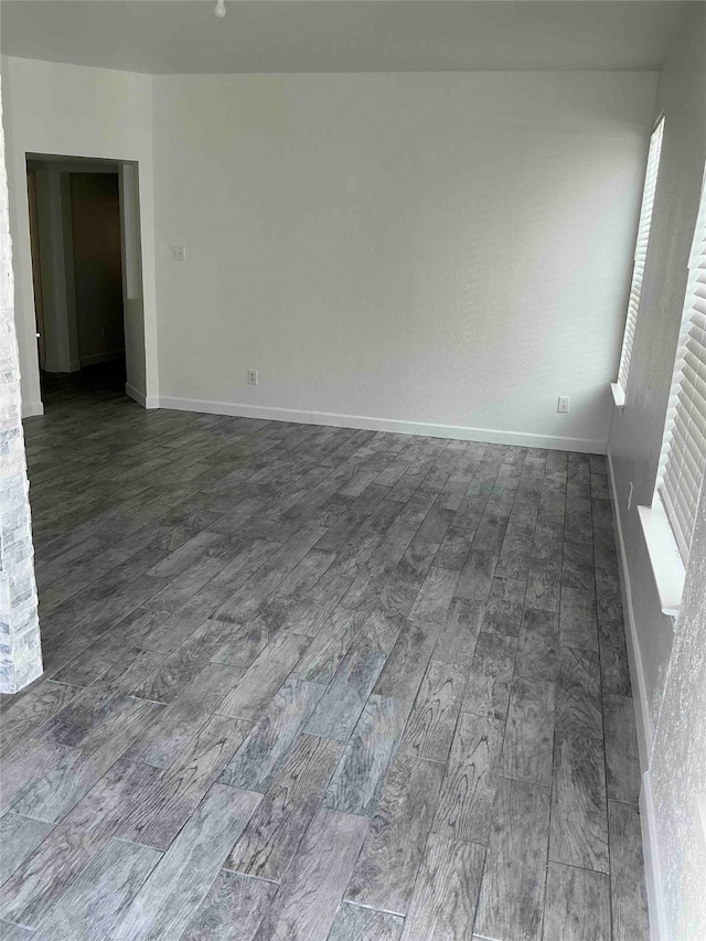 unfurnished room with dark hardwood / wood-style flooring