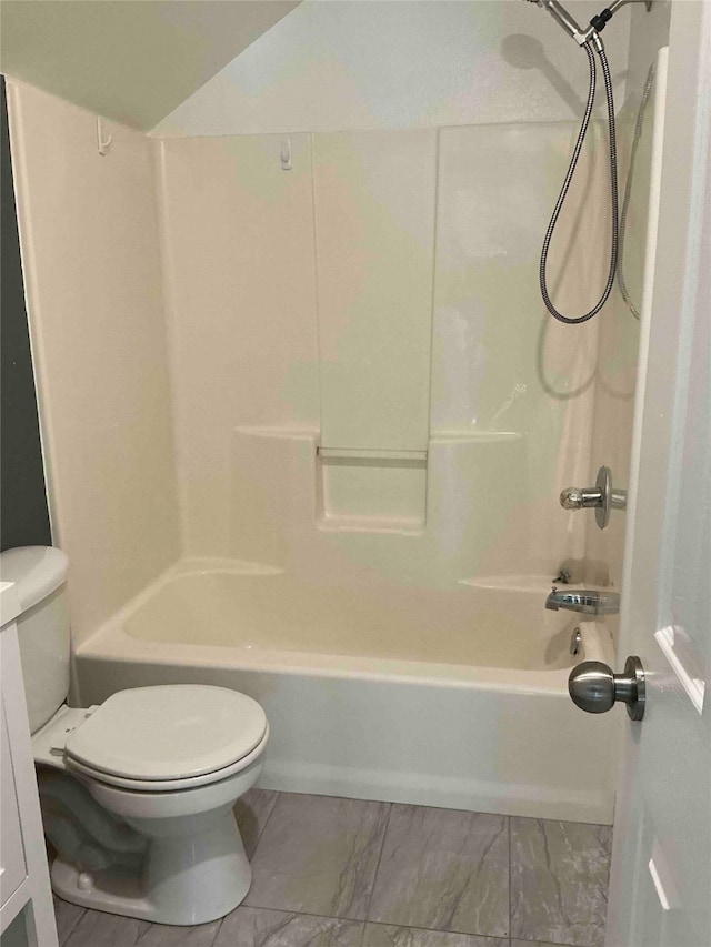 bathroom featuring shower / bath combination and toilet