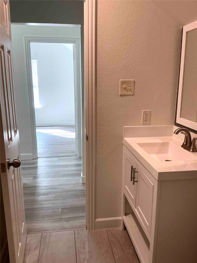 bathroom with hardwood / wood-style floors and vanity