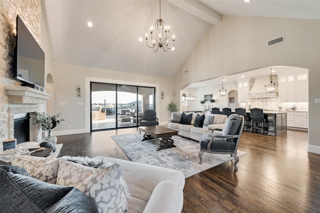 living room featuring high vaulted ceiling, a fireplace, dark hardwood / wood-style flooring, beam ceiling, and a notable chandelier