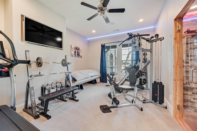 exercise room with light carpet and ceiling fan