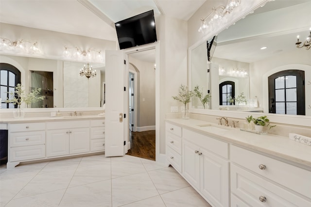 bathroom featuring a wealth of natural light, a chandelier, and vanity