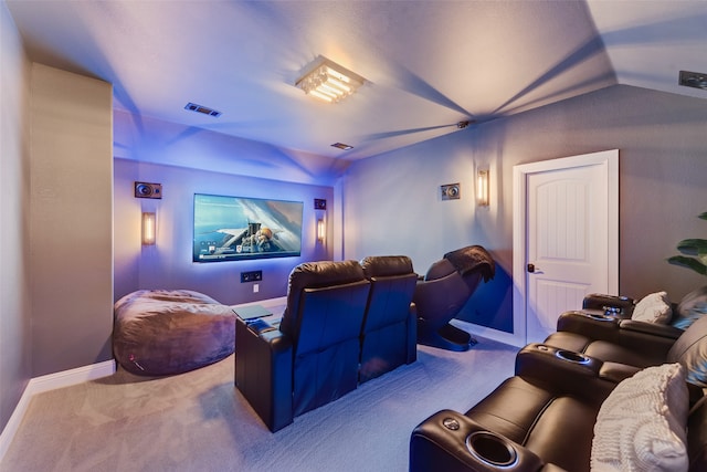 carpeted cinema featuring vaulted ceiling