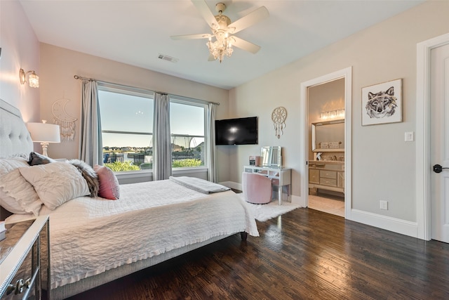 bedroom featuring ceiling fan, ensuite bath, and dark wood-type flooring