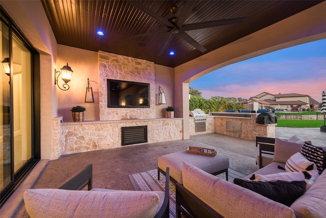 view of patio / terrace with an outdoor living space with a fireplace, area for grilling, and ceiling fan