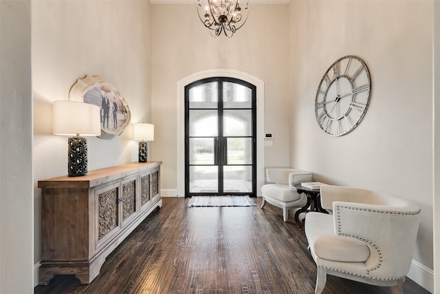 foyer entrance with a chandelier, dark hardwood / wood-style flooring, and a high ceiling