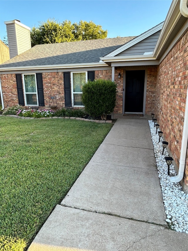 doorway to property with a yard