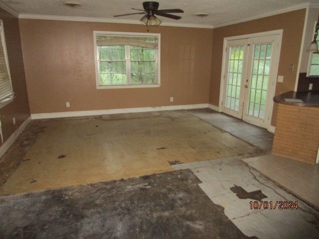 unfurnished room with ornamental molding, a wealth of natural light, ceiling fan, and french doors