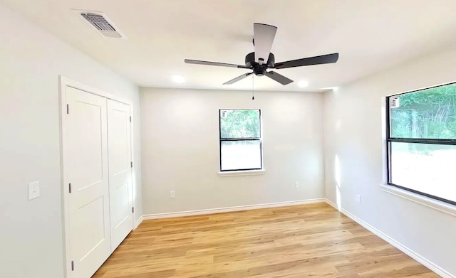 spare room with light hardwood / wood-style floors and ceiling fan