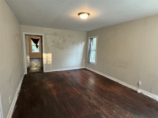 unfurnished room with dark hardwood / wood-style floors