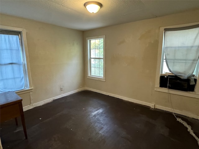 spare room featuring dark hardwood / wood-style floors and a textured ceiling