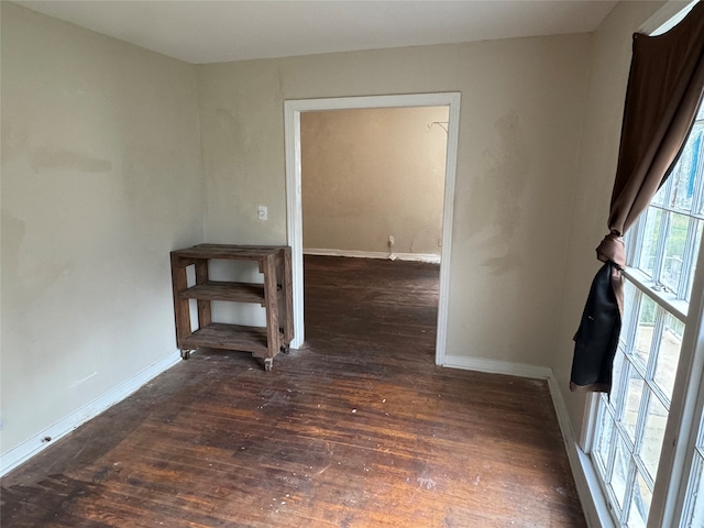 unfurnished room featuring dark wood-type flooring