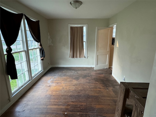 empty room with dark wood-type flooring