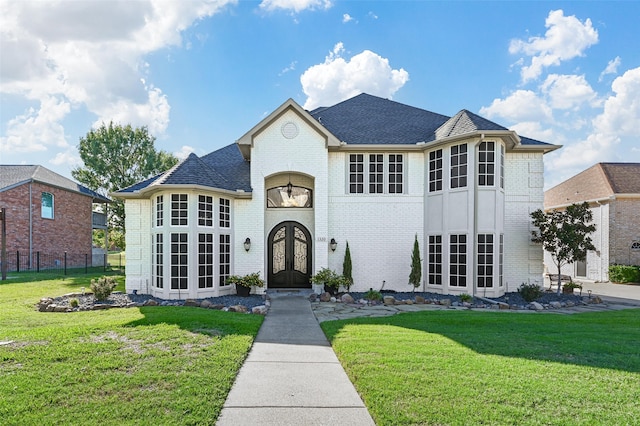 view of front of house featuring french doors and a front lawn