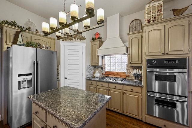 kitchen featuring a center island, dark hardwood / wood-style floors, backsplash, appliances with stainless steel finishes, and premium range hood