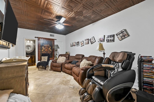 home theater with ceiling fan and light tile patterned floors