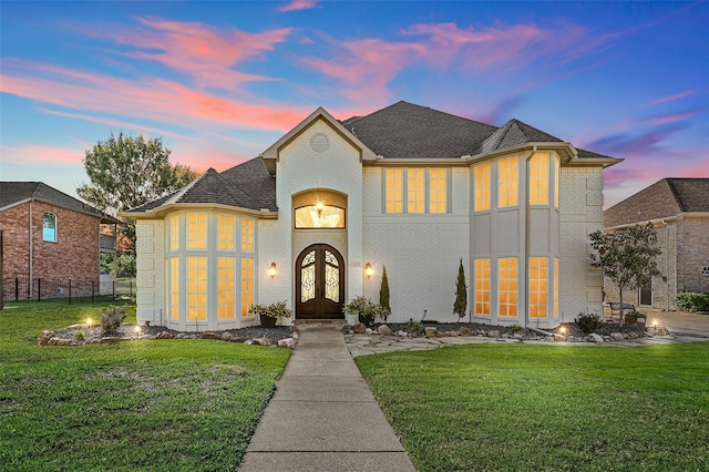 view of front facade featuring a yard and french doors