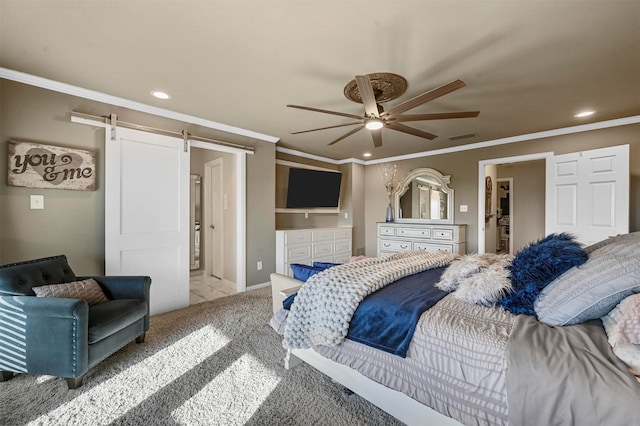 carpeted bedroom featuring a spacious closet, ceiling fan, crown molding, and a barn door