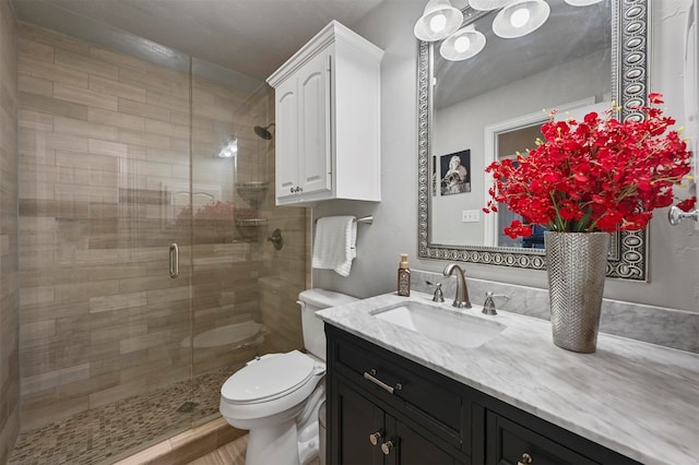 bathroom with wood-type flooring, vanity, toilet, and an enclosed shower