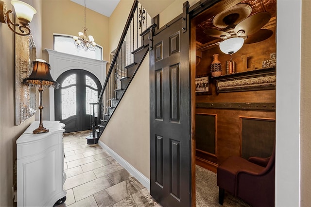 entrance foyer with a notable chandelier and a barn door