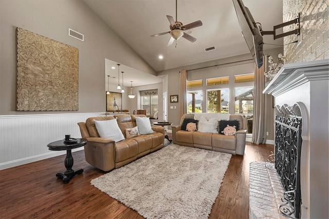 living room with high vaulted ceiling, ceiling fan, and dark hardwood / wood-style flooring