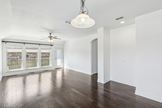 spare room with dark hardwood / wood-style flooring and ceiling fan