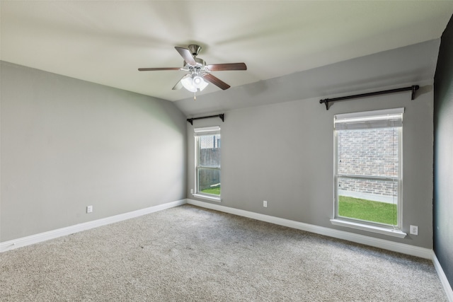 carpeted empty room featuring ceiling fan and lofted ceiling