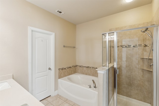 bathroom featuring shower with separate bathtub, tile patterned floors, and vanity