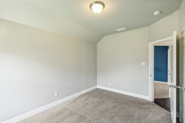 empty room featuring carpet floors and lofted ceiling