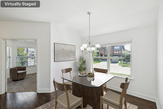 dining area featuring an inviting chandelier, lofted ceiling, and dark hardwood / wood-style floors