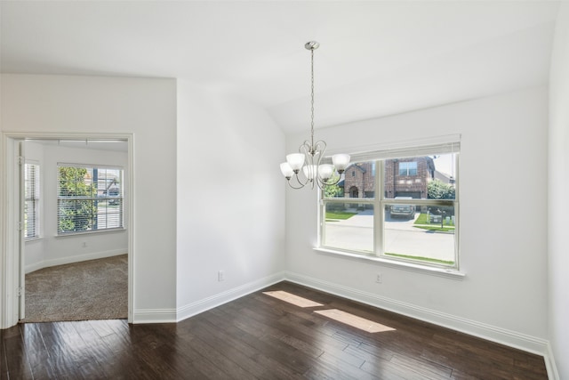 unfurnished room with vaulted ceiling, a notable chandelier, and dark hardwood / wood-style flooring